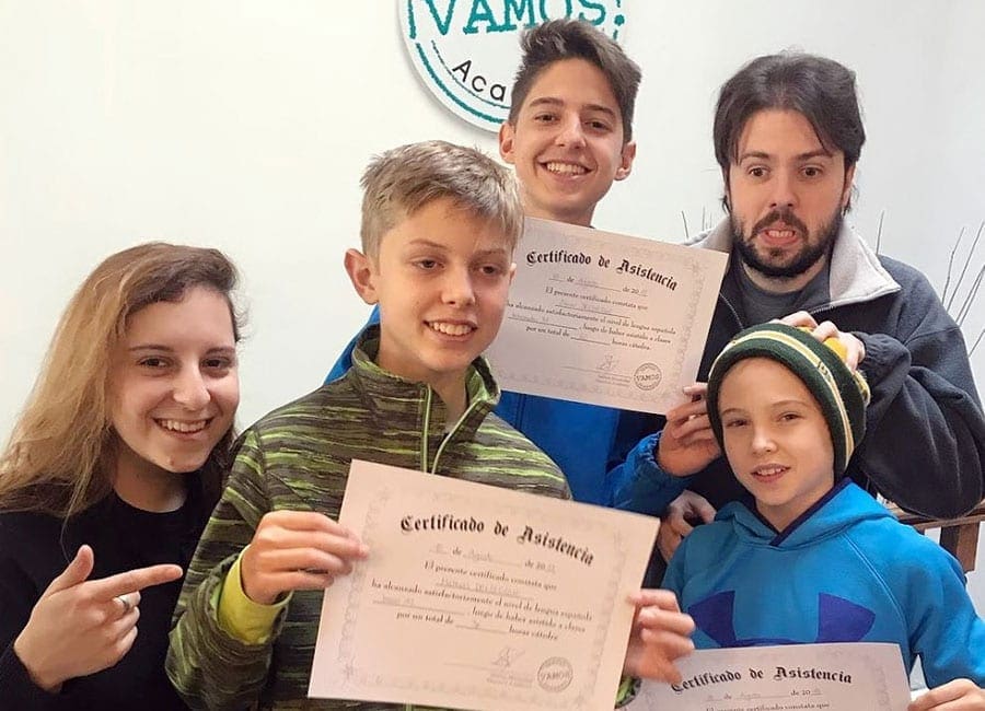 Vamos students holding their course certificates