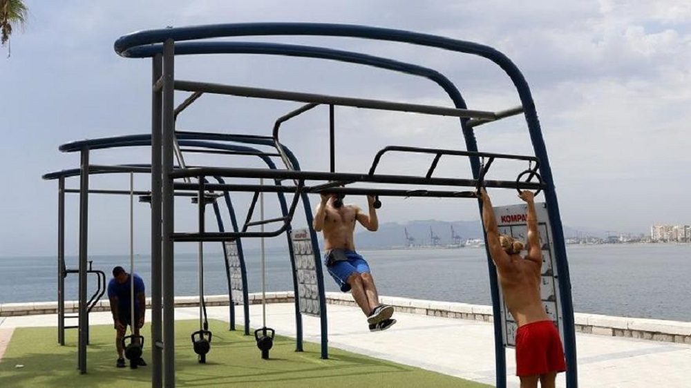 People working out in Huelin Beach in Malaga. Urban Workouts.